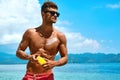 Man Tanning Using Sun Block Body Cream On Summer Beach Royalty Free Stock Photo