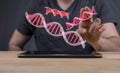 Man tapping red 3D illustrations of DNA structures - healthcare concept