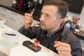 man tasting coffee in kitchen