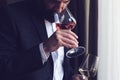Man tasting a glass of rose wine