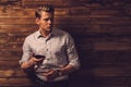 Man tasting wine in rural cottage interior