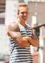 Man, tattoo and portrait with arms crossed smile for creativity design, unique ink or punk identity. Male person, face Royalty Free Stock Photo