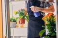 A man watering flowers in a pot. Royalty Free Stock Photo