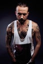 A man with tattooes on his arms. Silhouette of muscular body. caucasian brutal hipster guy with modern haircut, looking Royalty Free Stock Photo