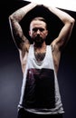 A man with tattooes on his arms. Silhouette of muscular body. caucasian brutal hipster guy with modern haircut, looking Royalty Free Stock Photo