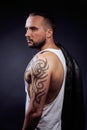 A man with tattooes on his arms. Silhouette of muscular body. caucasian brutal hipster guy with modern haircut, looking Royalty Free Stock Photo