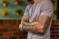 A man with tattoos on his arms. Generative AI Royalty Free Stock Photo