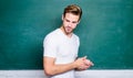 Man teacher in front of chalkboard. Teaching could be more fun. Advantages for male elementary teacher are abundant