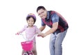 Man teaches his daughter to ride bicycle Royalty Free Stock Photo