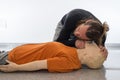Man teaching cardiopulmonary resuscitation with a dummy on a white background. Checking if the injured person breathes with the