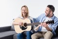 Man teaching happy woman playing acoustic guitar Royalty Free Stock Photo