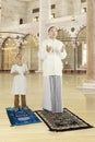 Man teaching his son praying in mosque Royalty Free Stock Photo