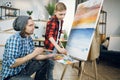 Man teaching little boy painting on canvas Royalty Free Stock Photo