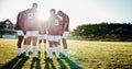 Man, team and holding hands in sports huddle for fitness, collaboration or goal on grass field. Group of men in circle Royalty Free Stock Photo