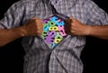 Man tears open shirt, under which there are bright multicolored letters alphabet, symbolizing knowledge. Royalty Free Stock Photo