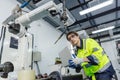 Man technician engineer using laptop control automation robotics at industrial modern factory. Male work checking automation robot Royalty Free Stock Photo