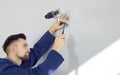 Man technician install surveillance camera on wall Royalty Free Stock Photo