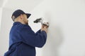 Man technician mount surveillance camera on wall Royalty Free Stock Photo