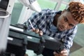 man technician trying to repair office printer at work Royalty Free Stock Photo