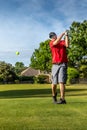 Man teeing off in the tee box, playing golf Royalty Free Stock Photo