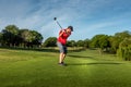 Man teeing off in the tee box, playing golf Royalty Free Stock Photo