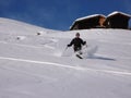 Man teelemark skiing in the Swiss backcountry in deep winter and fresh powder on a beautiful day Royalty Free Stock Photo