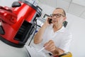 man on telephone next to vacuum cleaner and manual Royalty Free Stock Photo