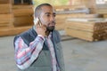 Man on telephone in woodyard Royalty Free Stock Photo
