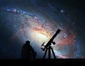 Man with telescope looking at the stars. Spiral Galaxy M106 Royalty Free Stock Photo