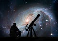 Man with telescope looking at the stars. Stellar Nursery NGC 1672. Spiral galaxy in the constellation Dorado.Elements of this