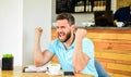 Man tense aggressive expression face sit cafe with mug of coffee and notepad. Headache and stress. Crisis creativity Royalty Free Stock Photo