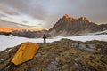 Man with tent observes the Alps