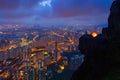 A man with tent standing on Suicide cliff in Hong Kong Downtown, China. Financial district and business centers in technology