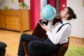 Man with terrestrial globe in his living room Royalty Free Stock Photo