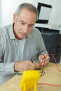 Man testing power using voltmeter Royalty Free Stock Photo