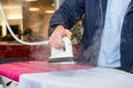 Man Testing Steam Iron Before Buying From Hypermarket