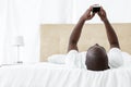 Man text messaging on mobile phone in bedroom Royalty Free Stock Photo