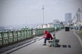 Man texting and street drinking on brighton promenade