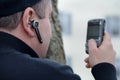 Man Texting & Wearing Wireless Earpiece