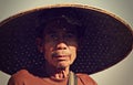 A man in Thailand wears a large bamboo hat Royalty Free Stock Photo