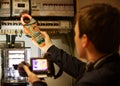 Man with thermal imaging camera checking electric installation with an amperemeter