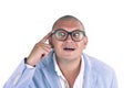 Man thinking while doing a silly face with nerd glasses Royalty Free Stock Photo