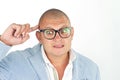 Man thinking while doing a silly face with nerd glasses isolated on white Royalty Free Stock Photo