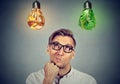 Man thinking looking up at vegetables light bulbs craving junk food Royalty Free Stock Photo