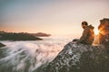 Man thinking sitting alone on cliff edge mountain top