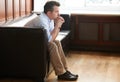 Man, thinking and stress on sofa in waiting room for interview, recruitment or loss of job. Businessman, anxiety and