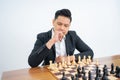 Man thinks before stepping when playing chess on isolated background