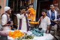 Man threading colourful flower garlands in Delhi