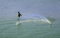 Man throw a net on the sea backwater