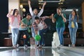 Man throwing ball and spending time with friends in bowling Royalty Free Stock Photo